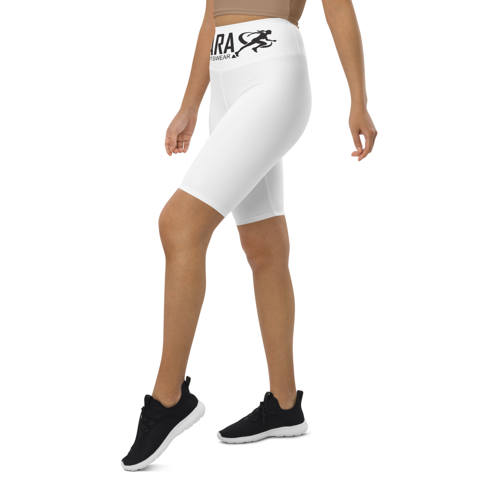 A model wearing T.A.R.A Sportswear high-waisted white biker shorts with a visible brand logo on the waistband.