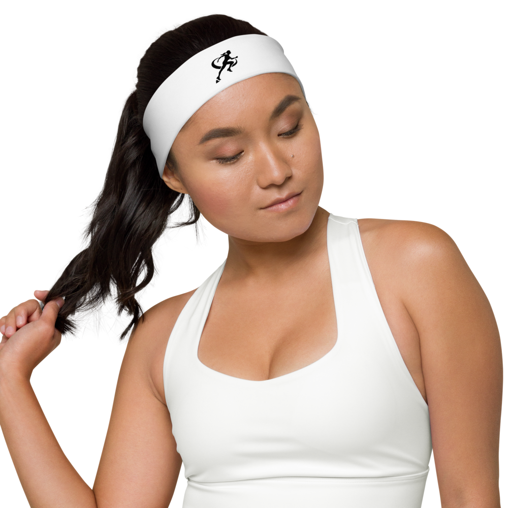 A woman wearing a white T.A.R.A Sportswear headband with a logo on the front.