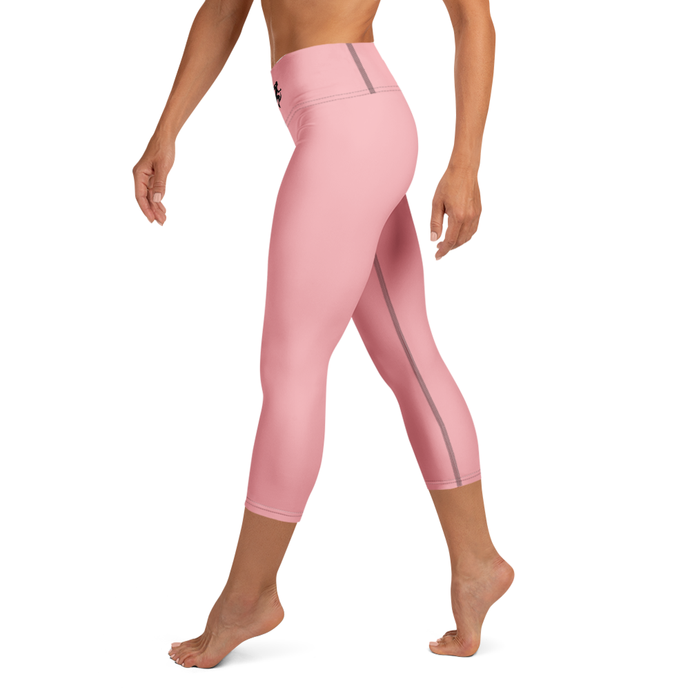 Woman holding a surfboard on a beach with a sunset background