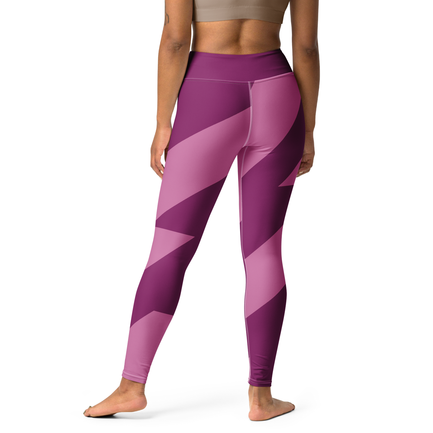 Woman wearing pink leggings with 'TARA' branding outdoors.