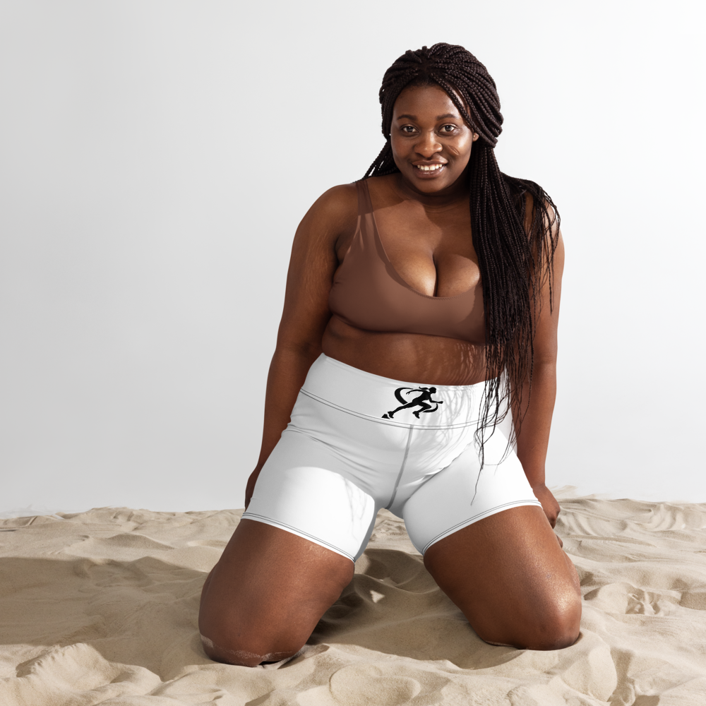 A woman is crouching on one knee wearing white high-waisted yoga shorts with a drawstring and a brown top.