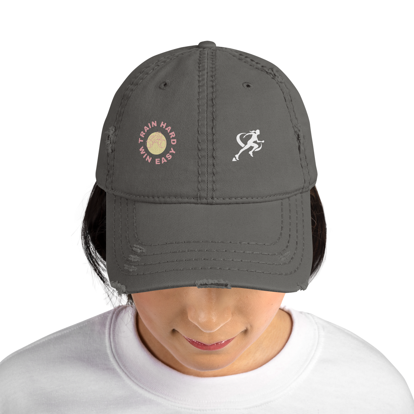 Woman wearing a dark gray cap with embroidered designs on a white background