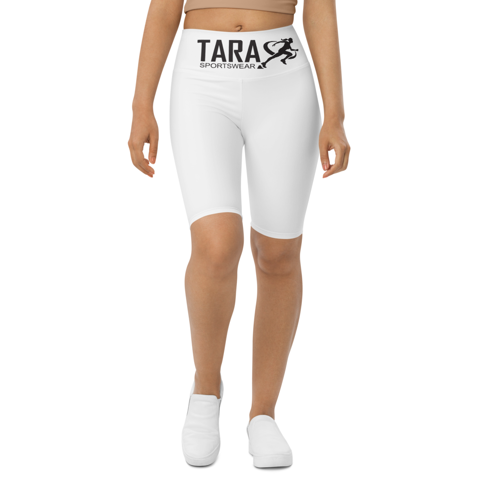 A model wearing T.A.R.A Sportswear high-waisted white biker shorts with a visible brand logo on the waistband.