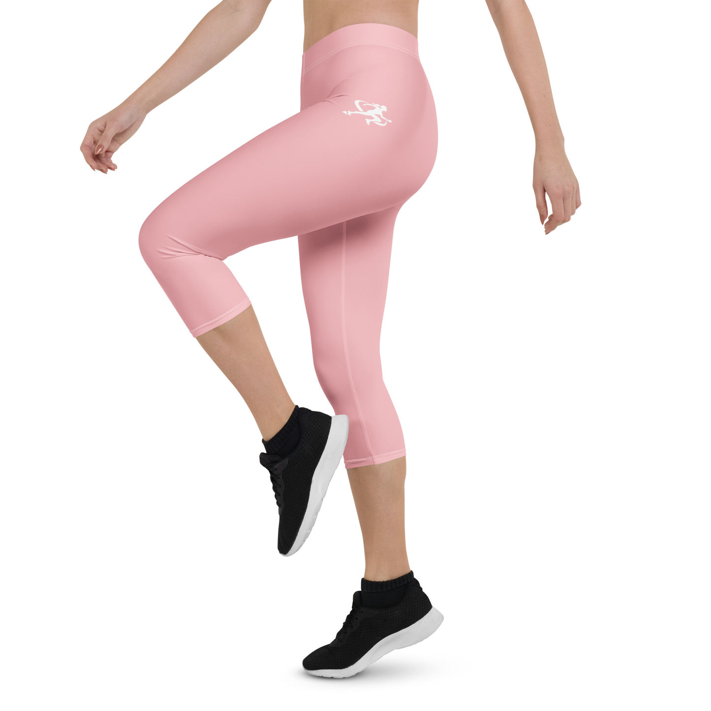 Person wearing pink leggings with a logo and black athletic shoes on a white background