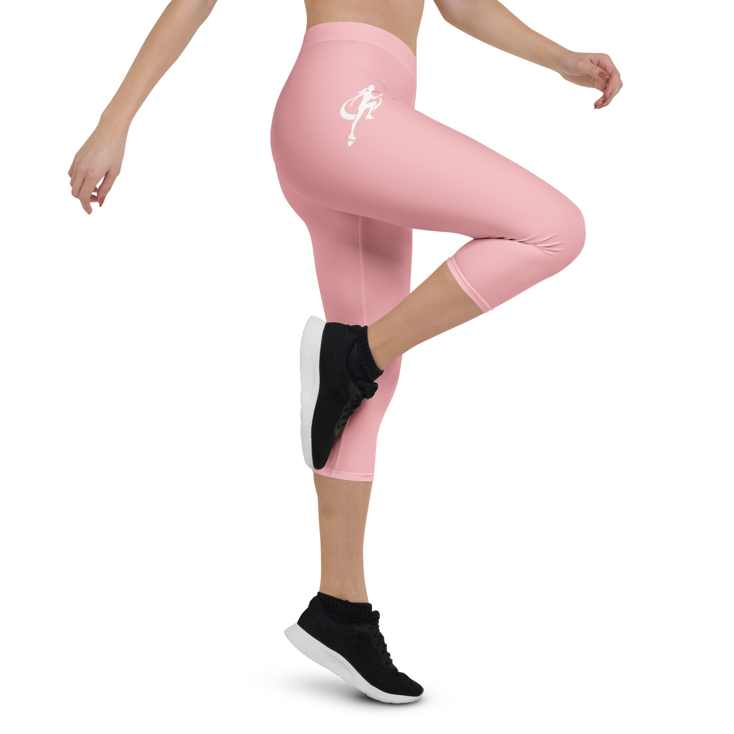 Person wearing pink leggings with a logo and black athletic shoes on a white background