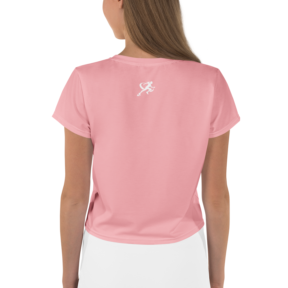 Woman wearing a pink t-shirt with 'TARA' printed on it against a white background