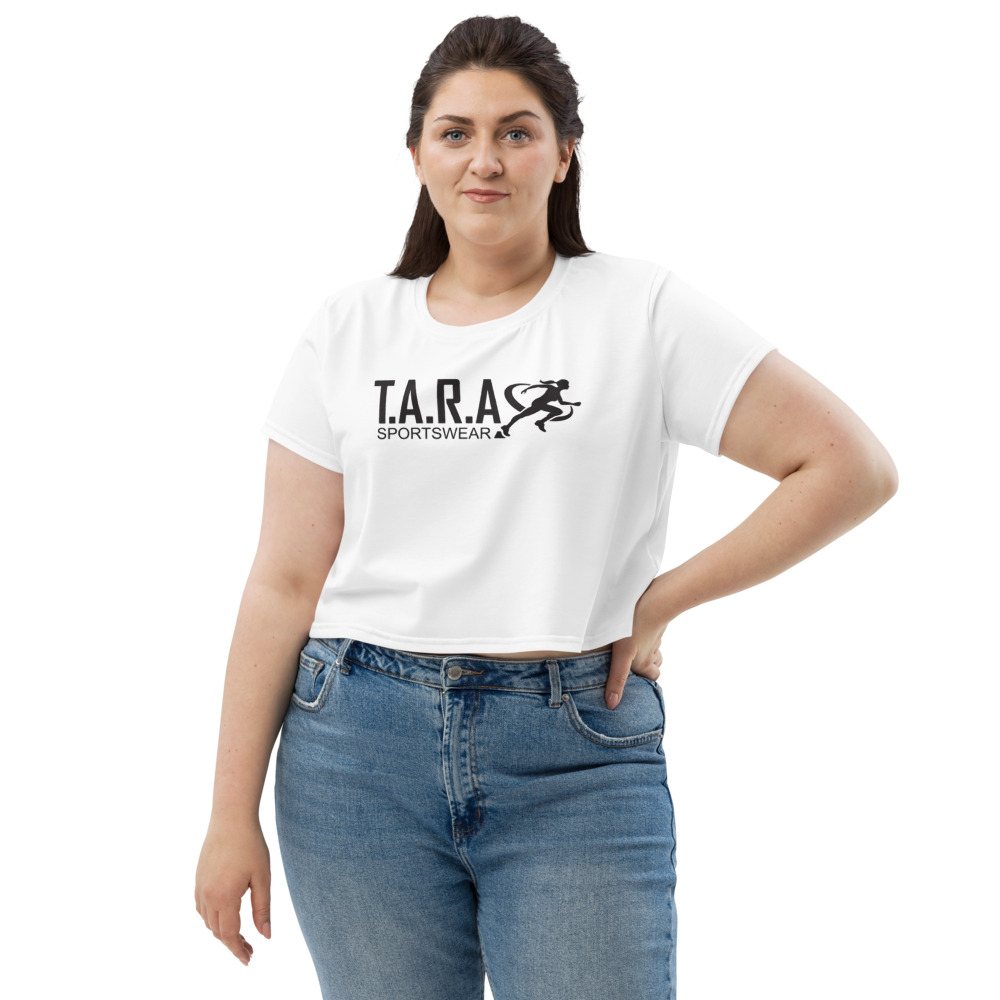 A female model wearing a white crop top with the T.A.R.A Sportswear logo on the front.