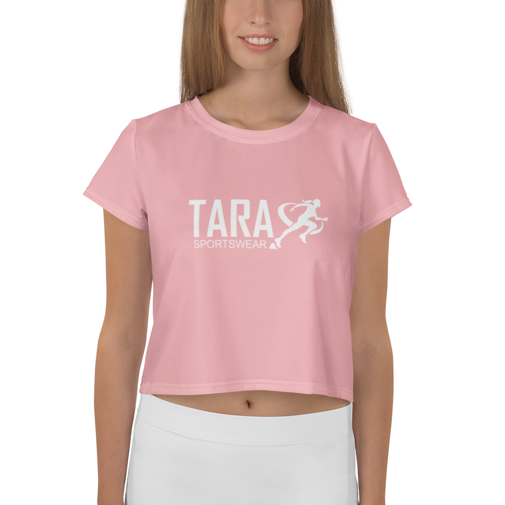 Woman wearing a pink t-shirt with 'TARA' printed on it against a white background