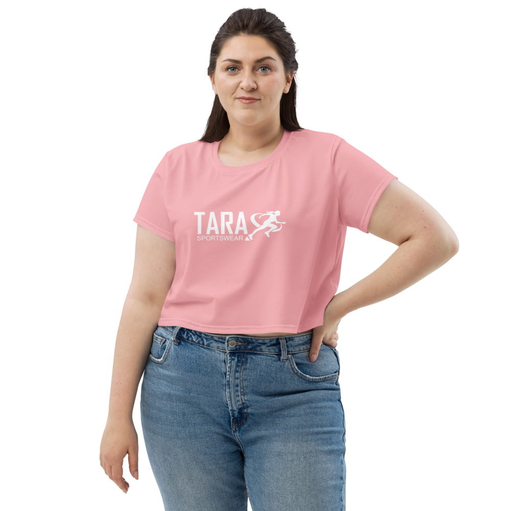 Woman wearing a pink t-shirt with 'TARA' printed on it against a white background