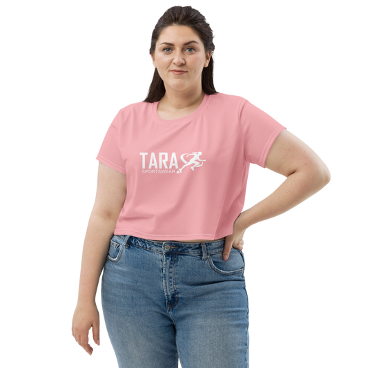 Woman wearing a pink t-shirt with 'TARA' printed on it against a white background