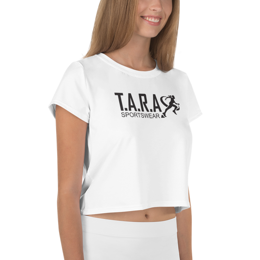 A female model wearing a white crop top with the T.A.R.A Sportswear logo on the front.