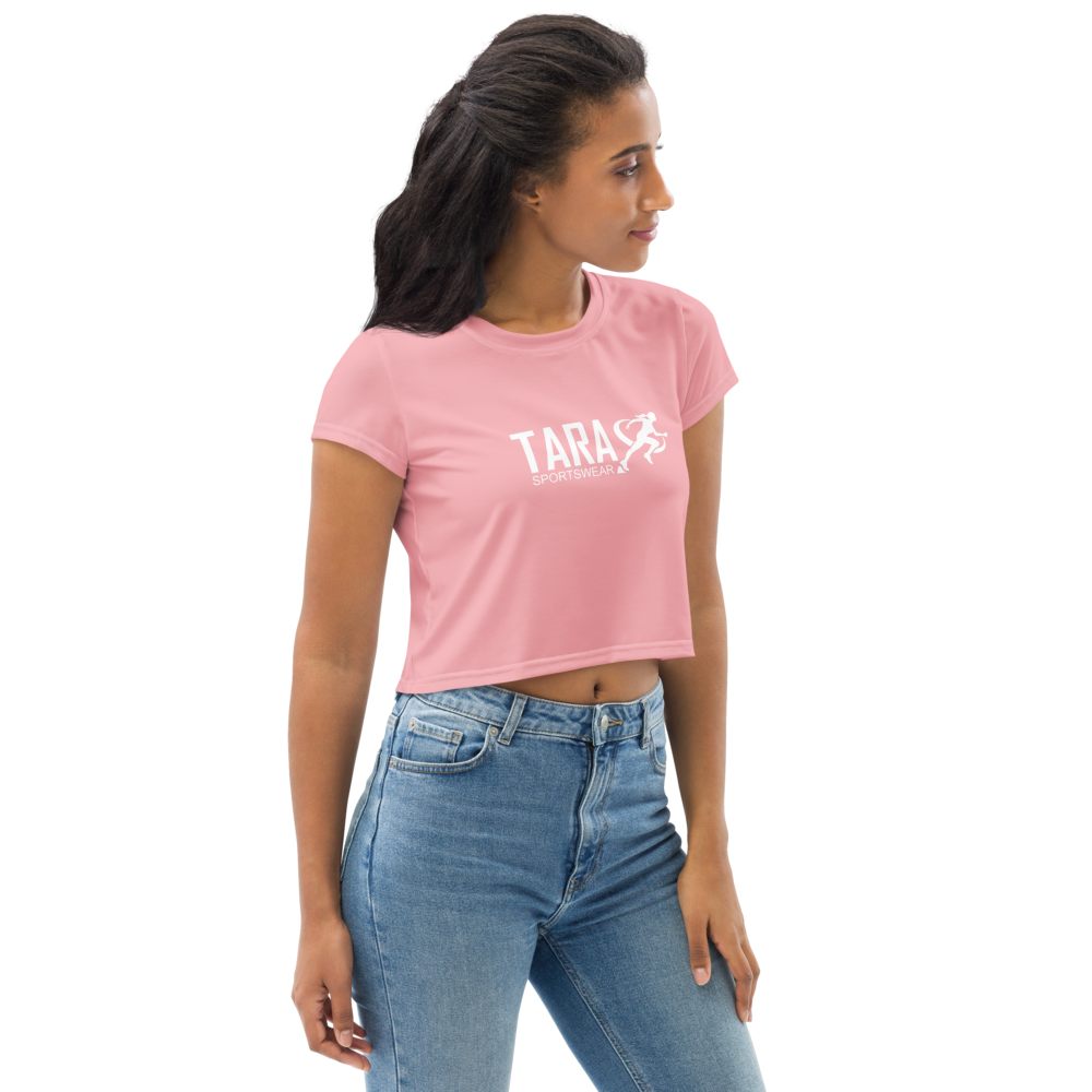 Woman wearing a pink t-shirt with 'TARA' printed on it against a white background