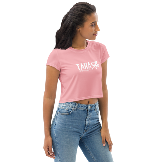 Woman wearing a pink t-shirt with 'TARA' printed on it against a white background