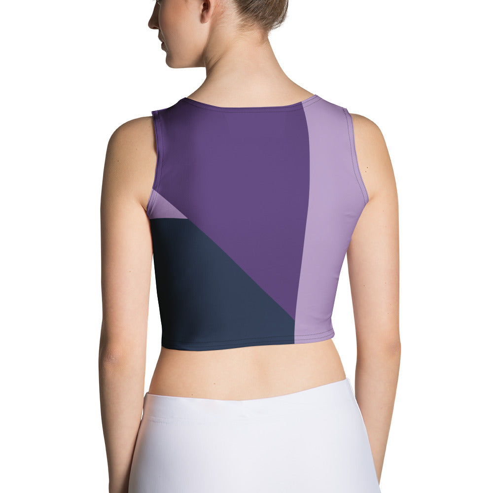 Woman wearing a purple tank top and white jeans on a white background