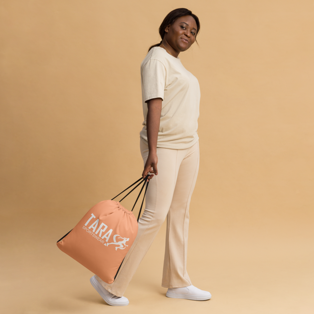 Person wearing a peach backpack featuring 'TARA SPORTSWEAR' on a orange background