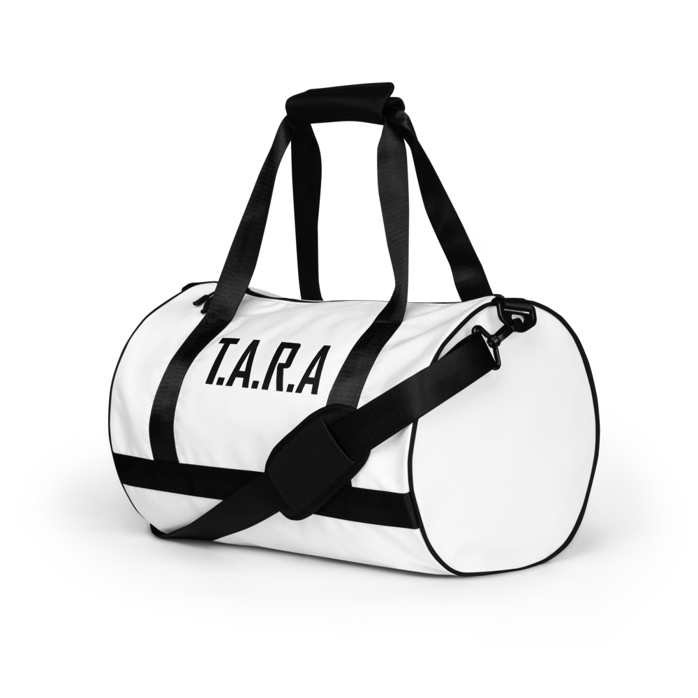 White duffel bag with black straps and 'T.A.R.A.' text on a white background