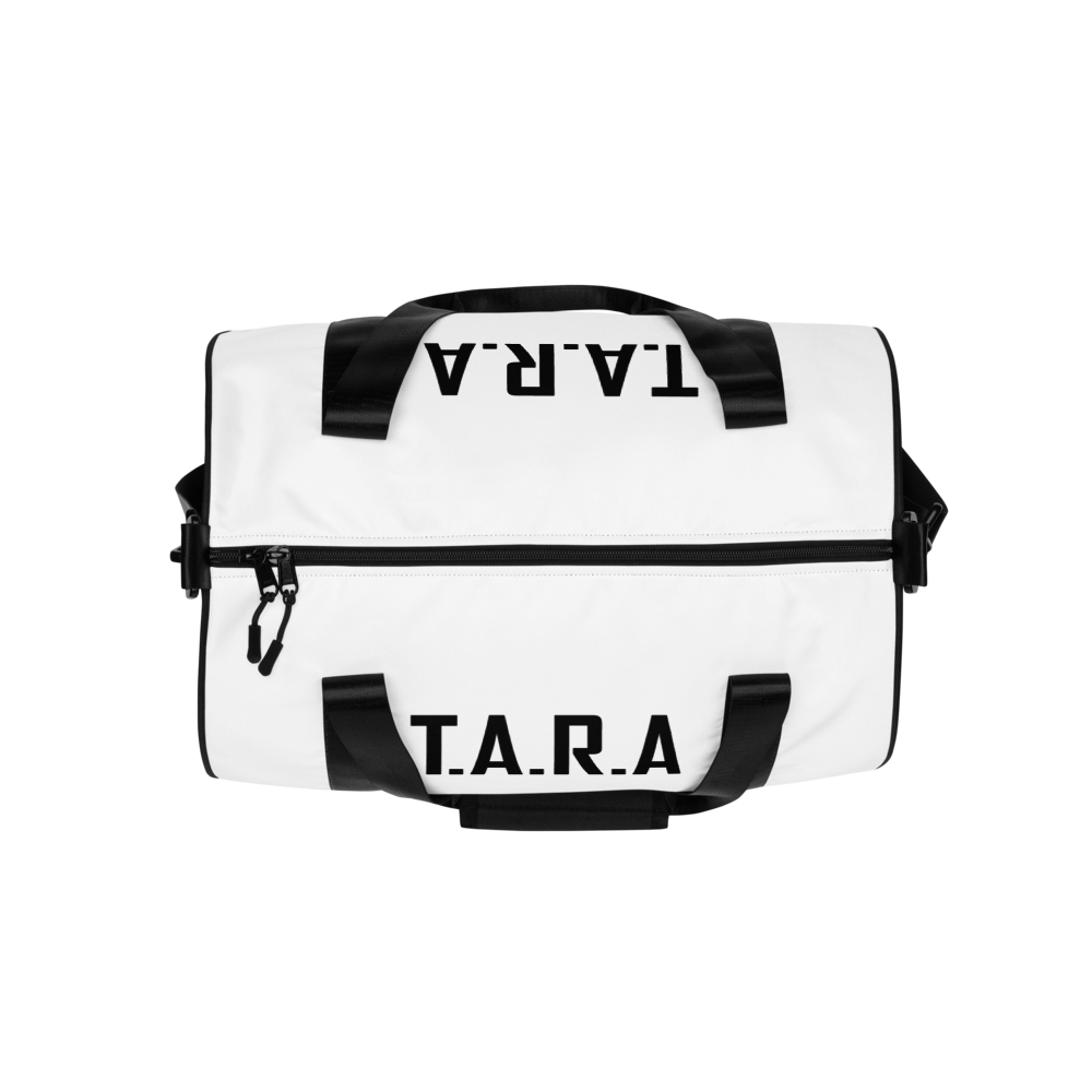 White duffel bag with black straps and 'T.A.R.A.' text on a white background