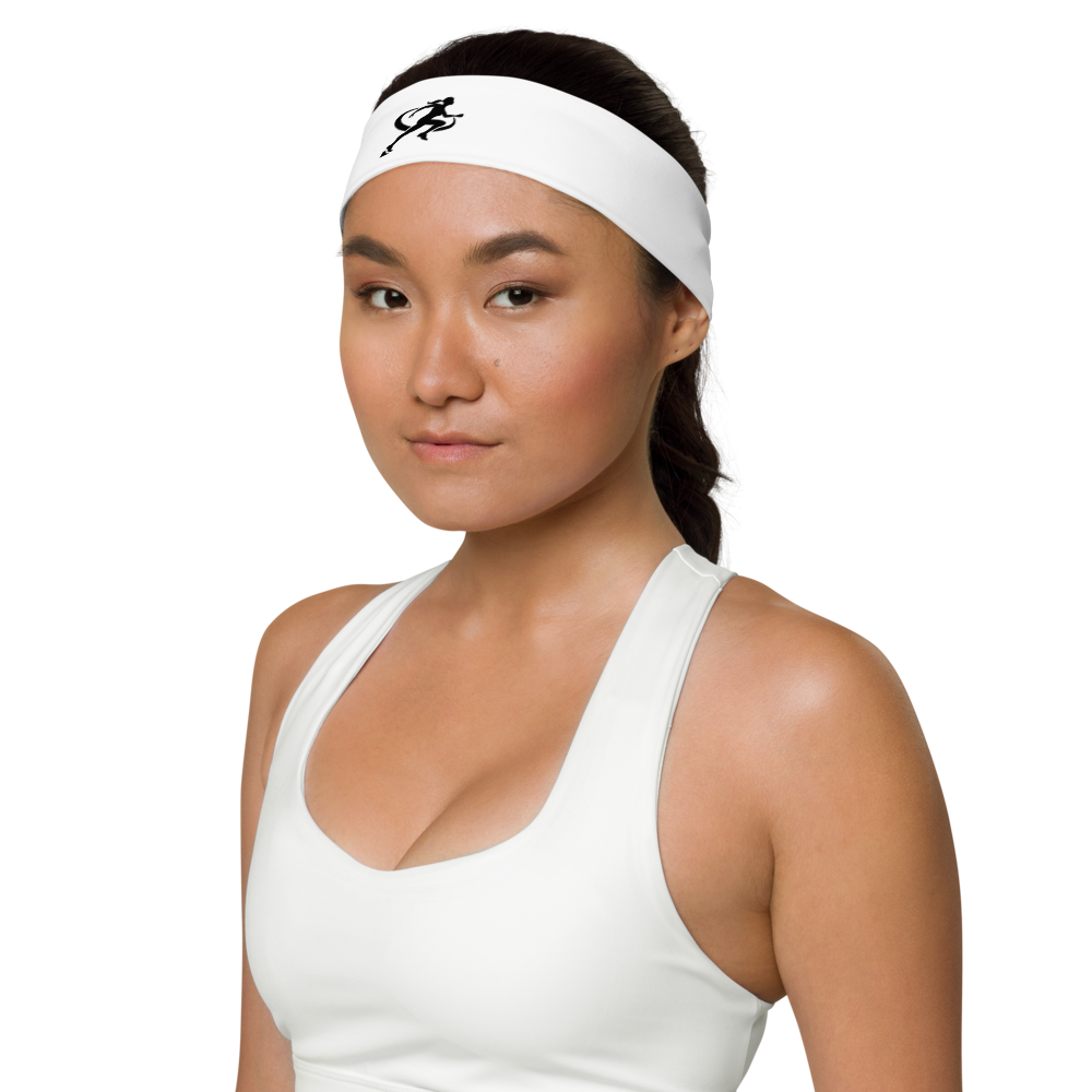 A woman wearing a white T.A.R.A Sportswear headband with a logo on the front.