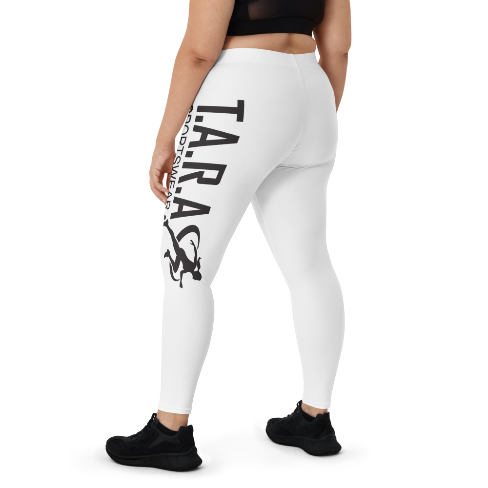 A model wearing high waisted white sportswear leggings with a logo on the side, paired with black sneakers from the side.