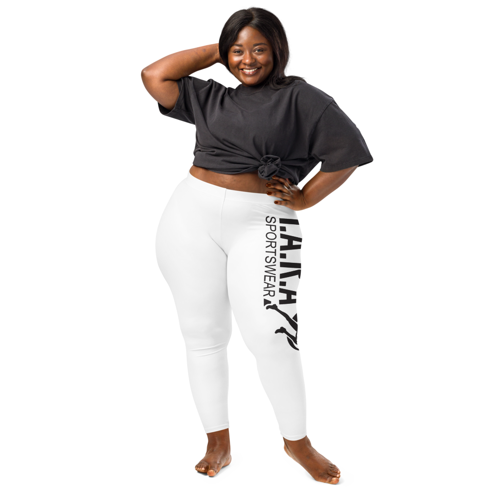 A model wearing high waisted white sportswear leggings with a logo on the side, bear footed. 