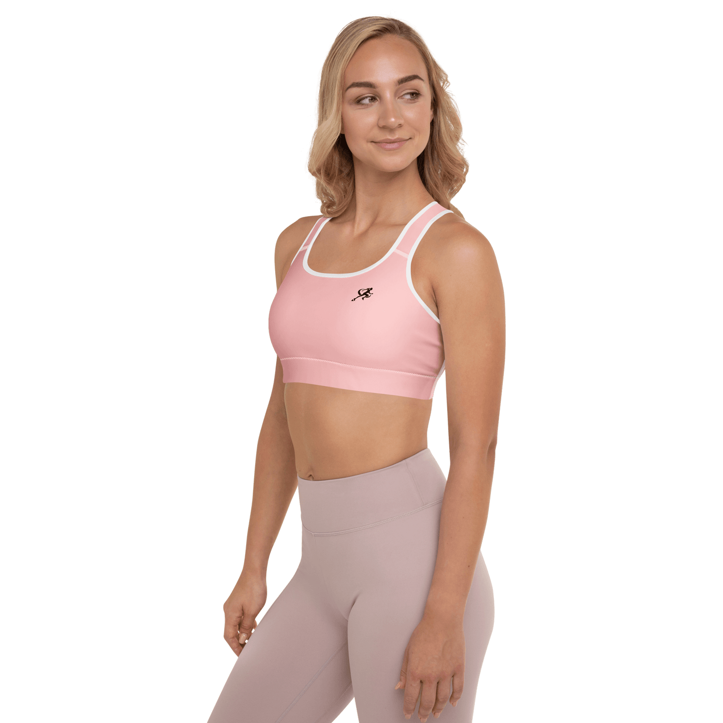 Woman wearing a pink sports bra and leggings on a white background