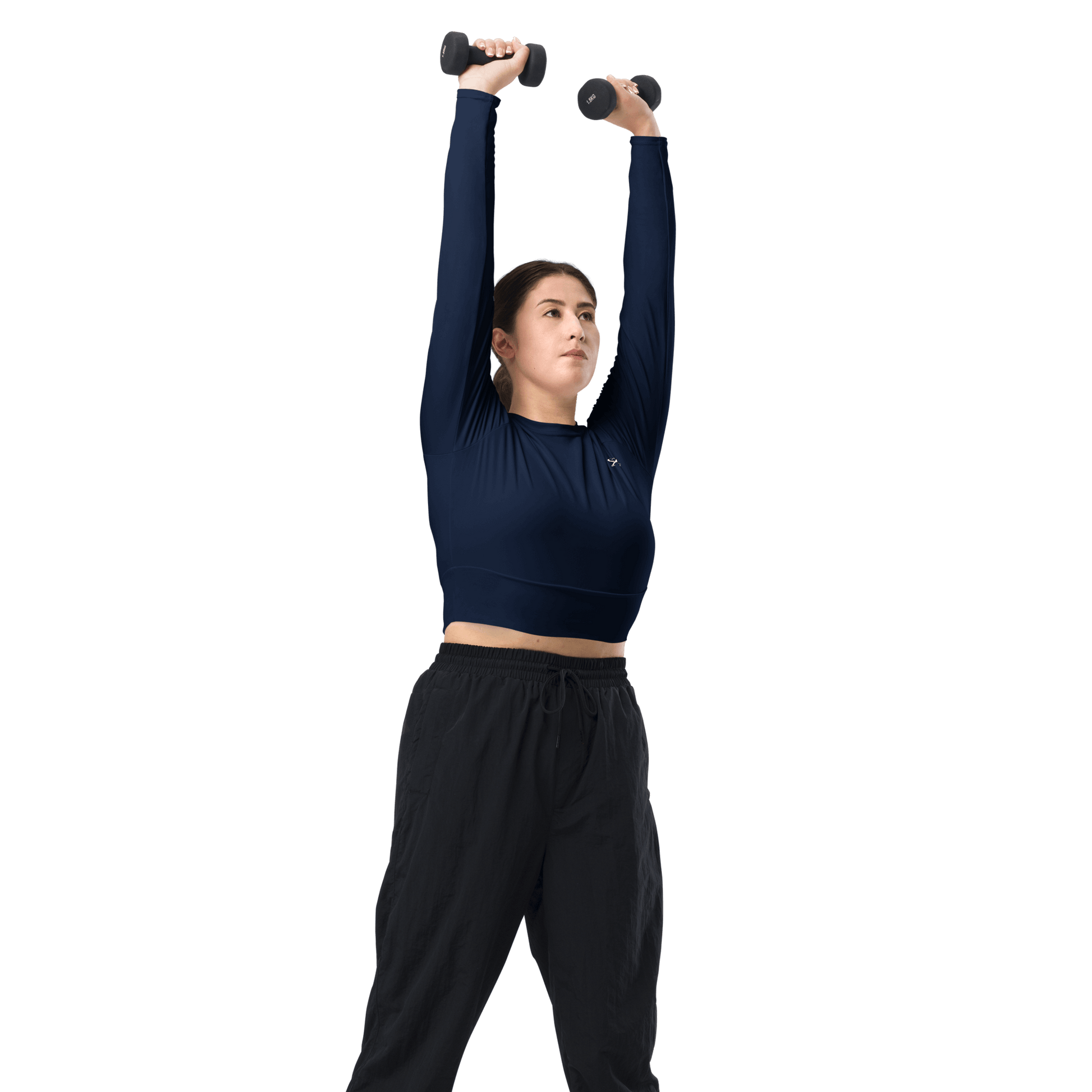 Woman wearing a navy long-sleeve top and beige shorts against a beige background