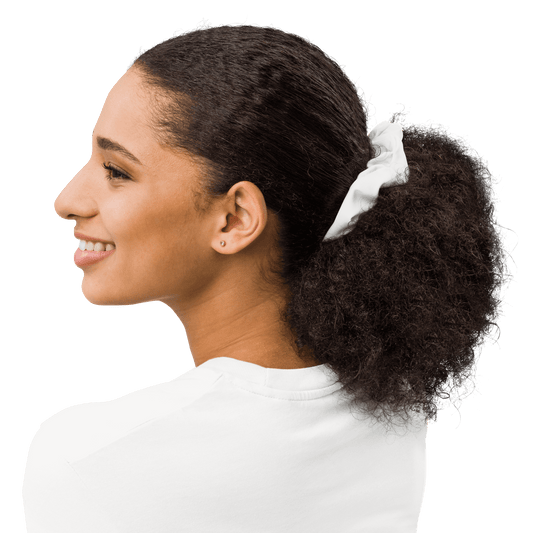 Woman with a white scrunchie in her hair on a white background
