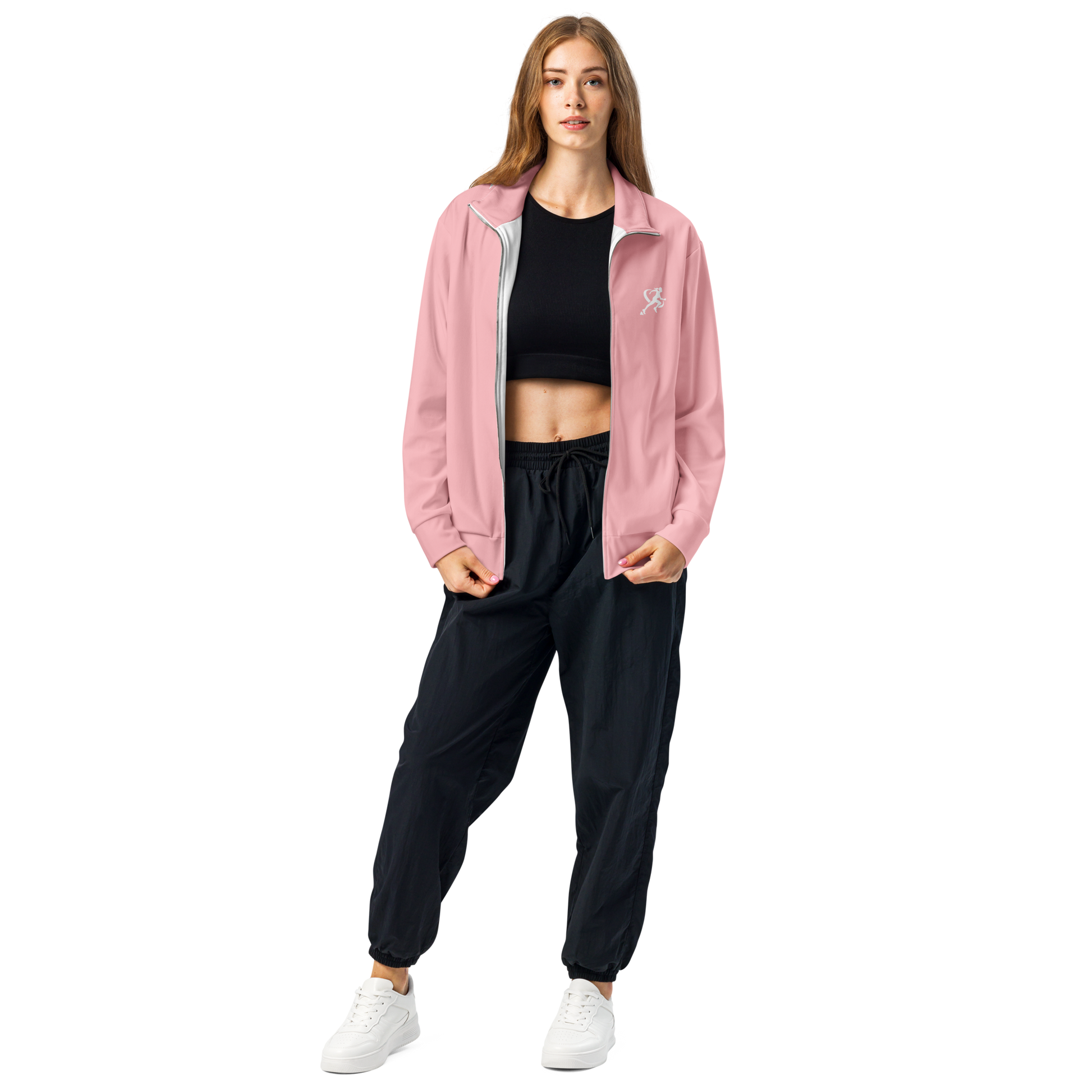 Woman wearing a pink jacket and black pants on a white background