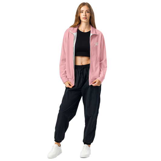 Woman wearing a pink jacket and black pants on a white background