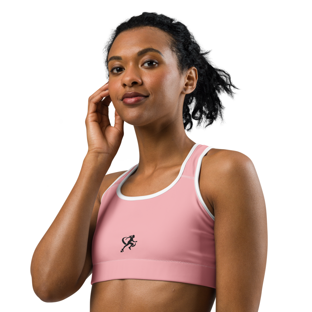 Woman wearing a pink sports bra and beige leggings on a white background