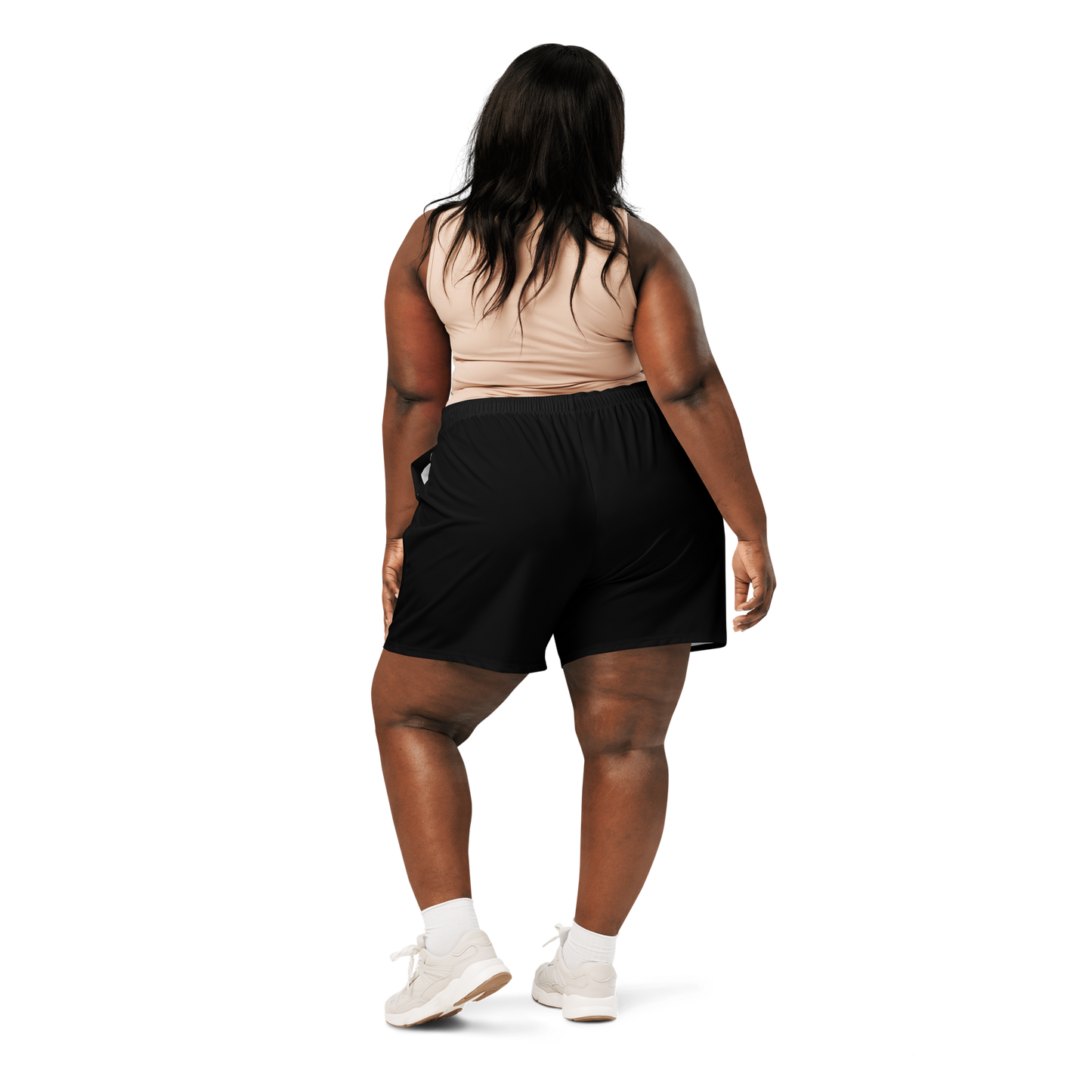 Woman wearing a sports bra and black shorts on a white background