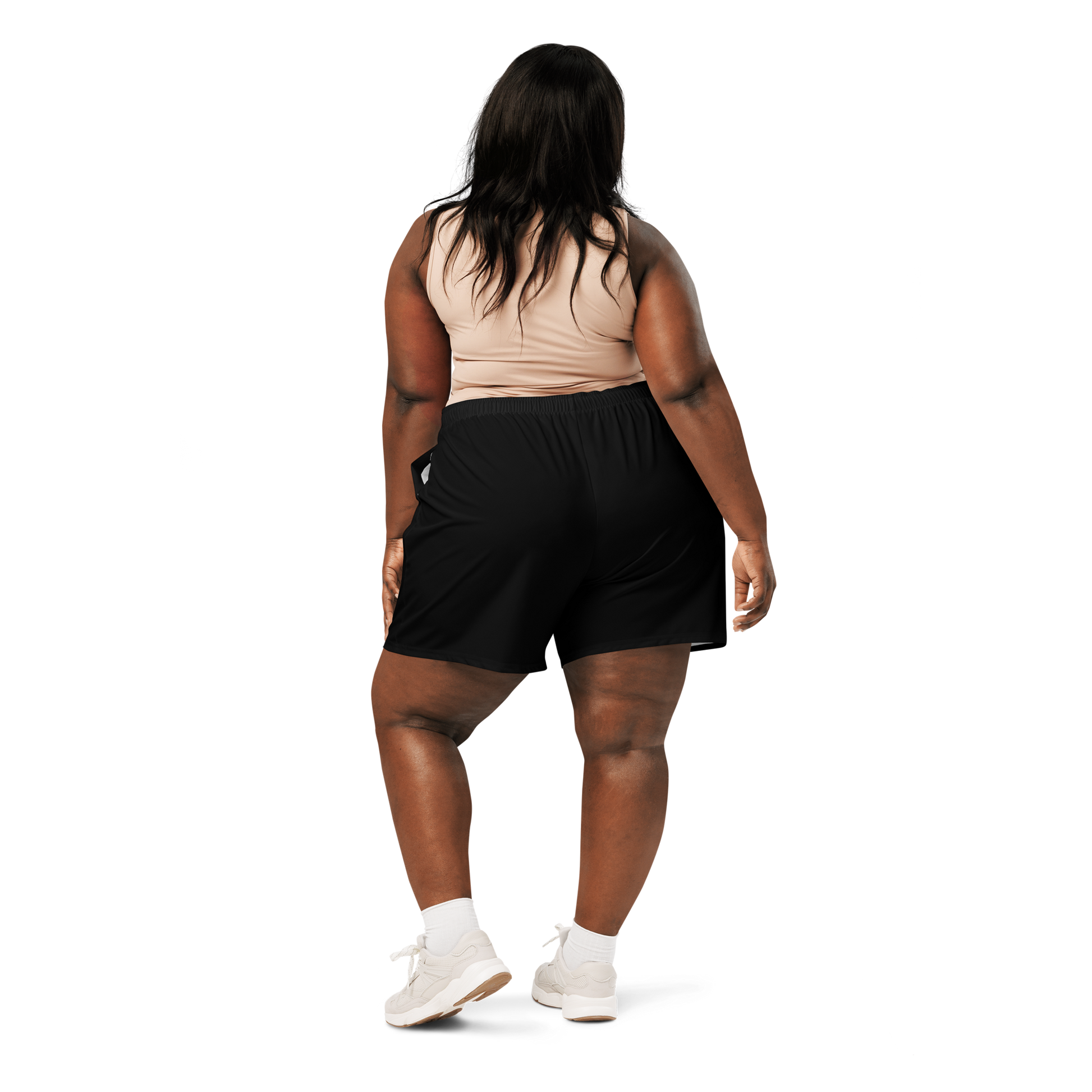 Woman wearing a sports bra and black shorts on a white background