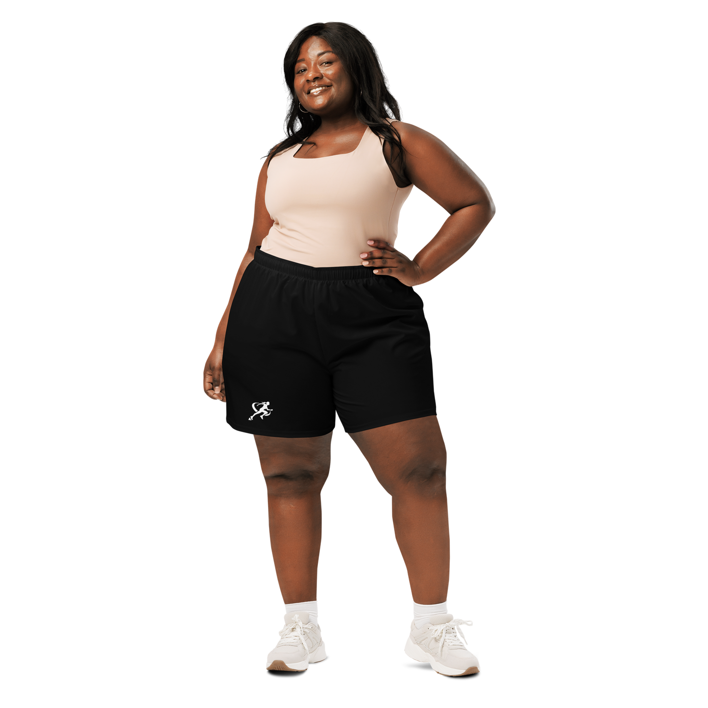 Woman wearing a sports bra and black shorts on a white background