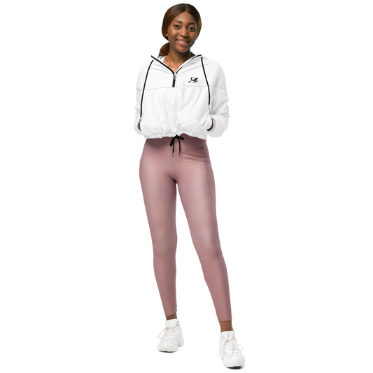 Person wearing a white jacket and pink leggings on a white background