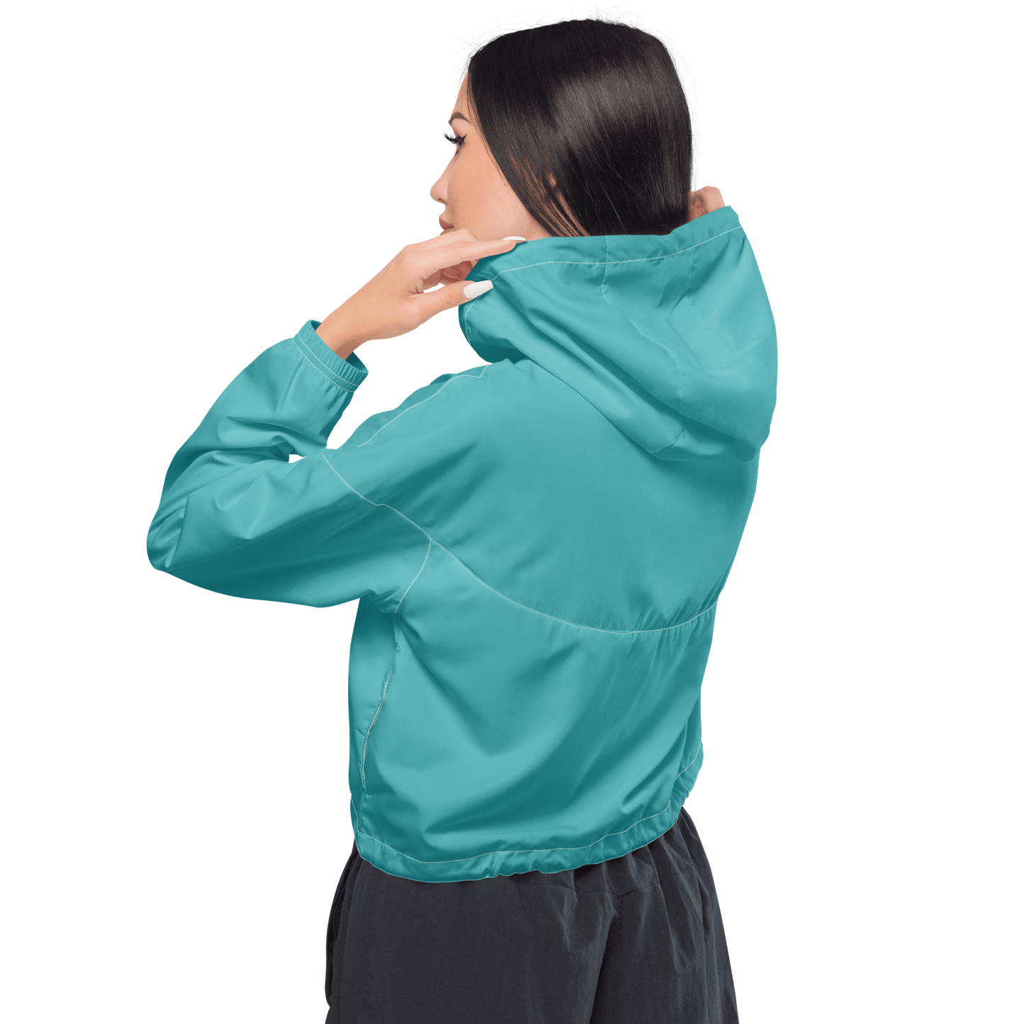 Woman wearing a turquoise jacket and black pants on a white background