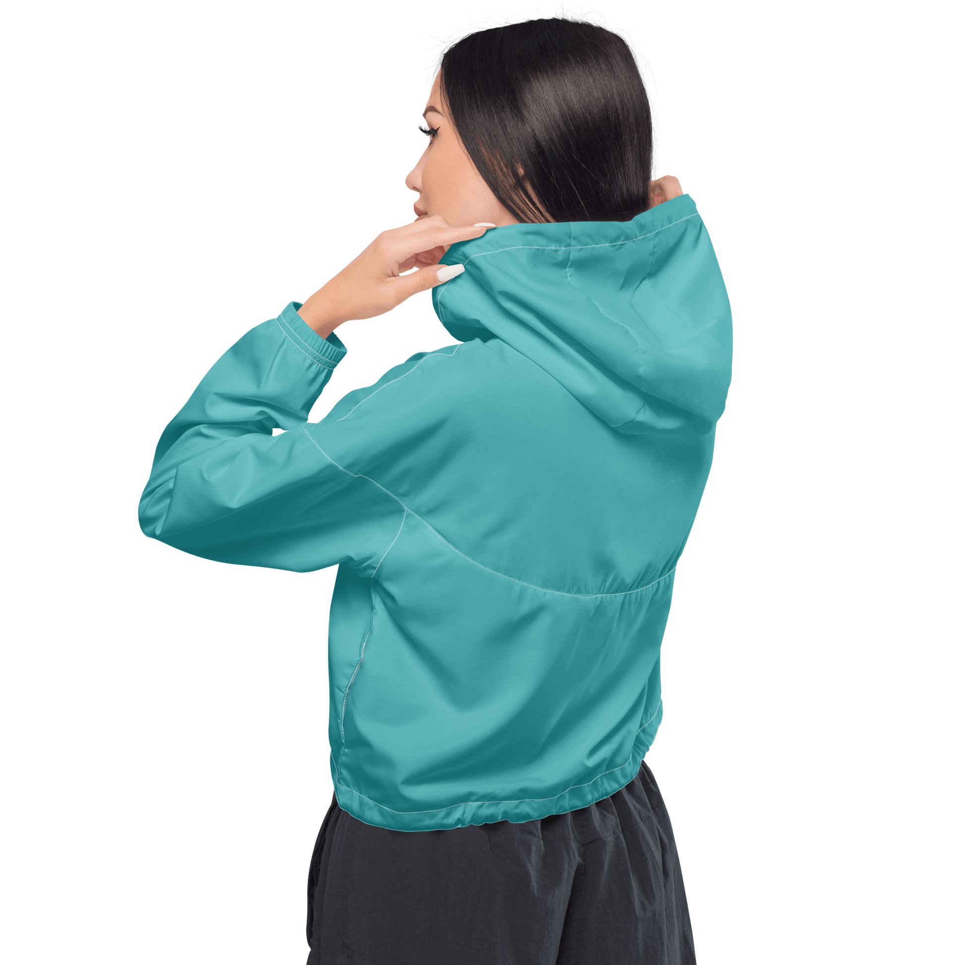 Woman wearing a turquoise jacket and black pants on a white background