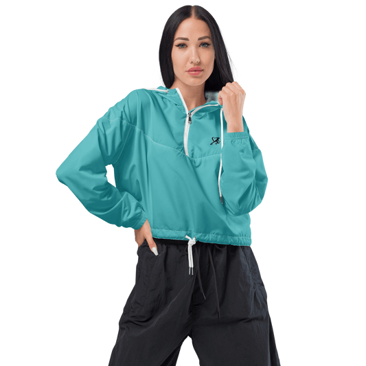 Woman wearing a turquoise jacket and black pants on a white background