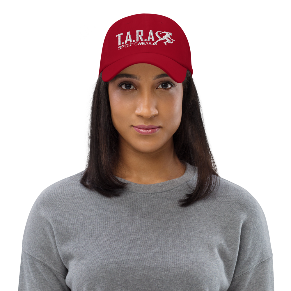 A woman wearing a red cap with the logo 'T.A.R.A Sportswear' on the front.