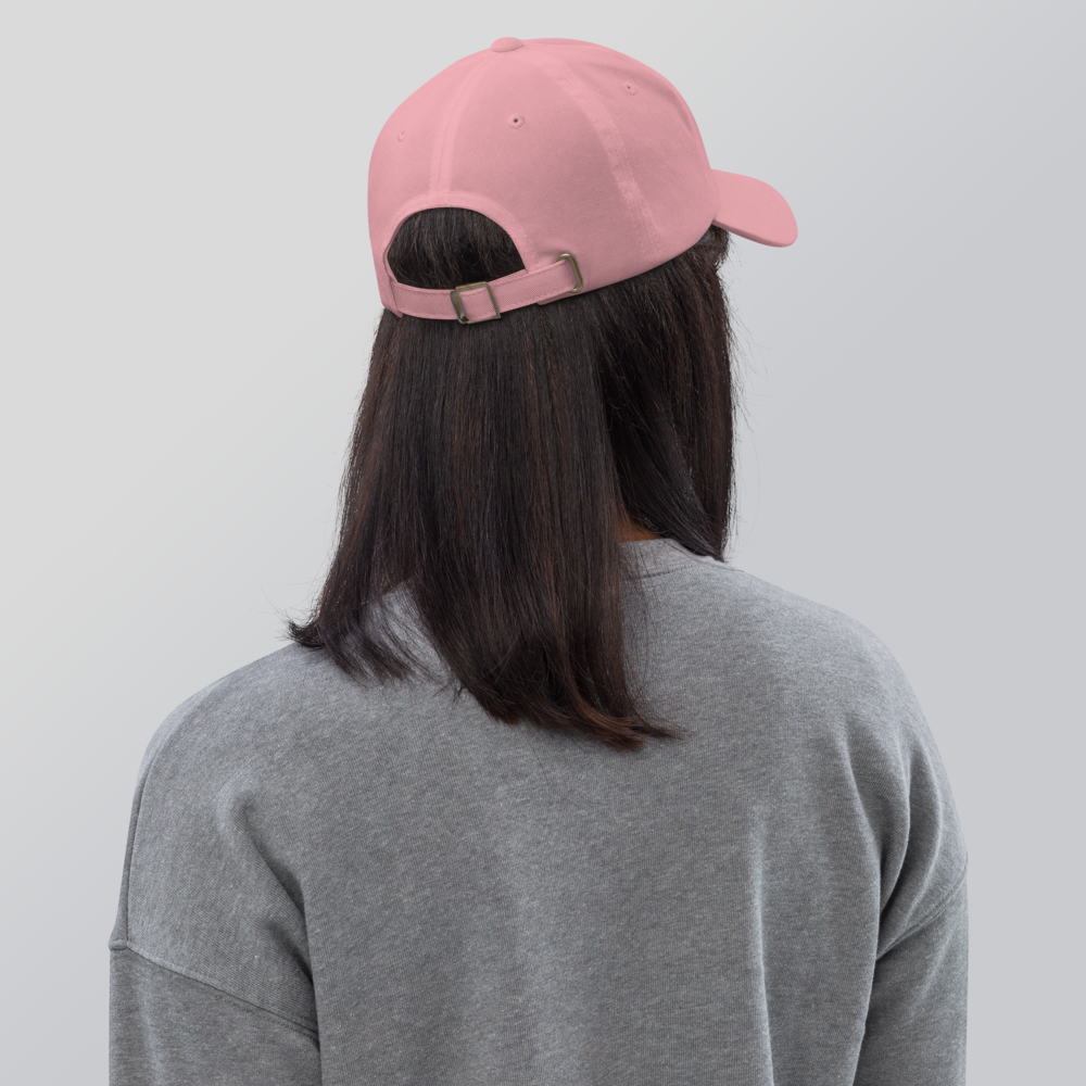 A woman wearing a pink cap with the logo 'T.A.R.A Sportswear' on the back
