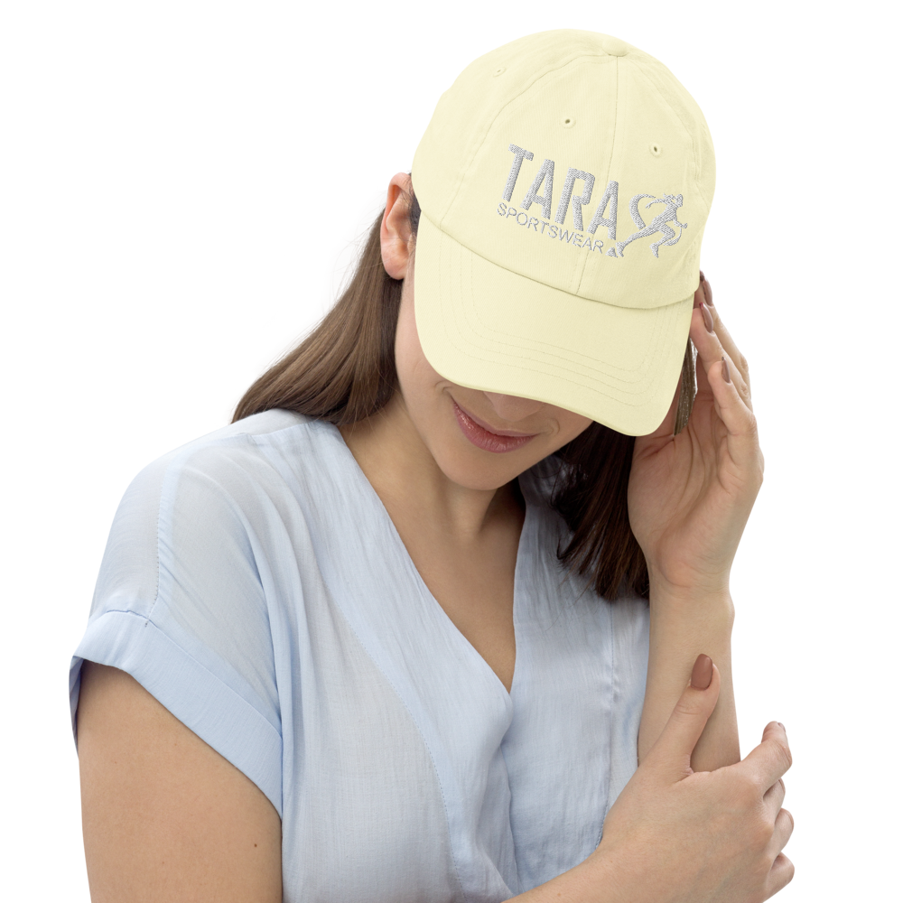 Woman wearing a light yellow cap with a logo on a white background