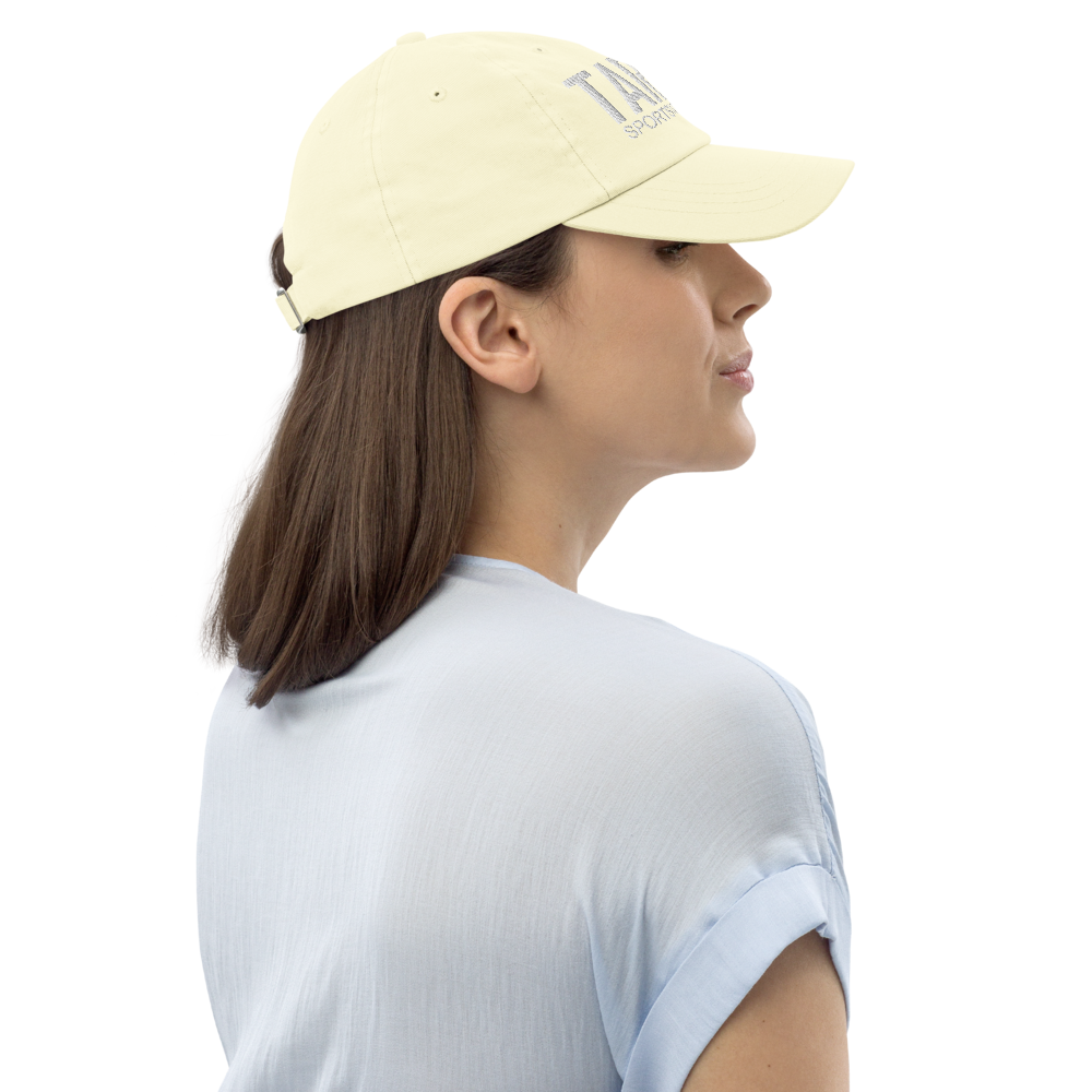 Woman wearing a light yellow cap with a logo on a white background