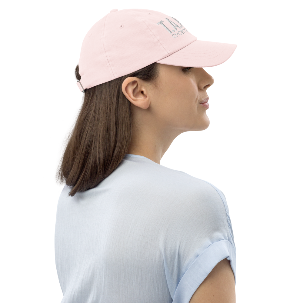 Woman wearing a pink cap with a logo on a white background