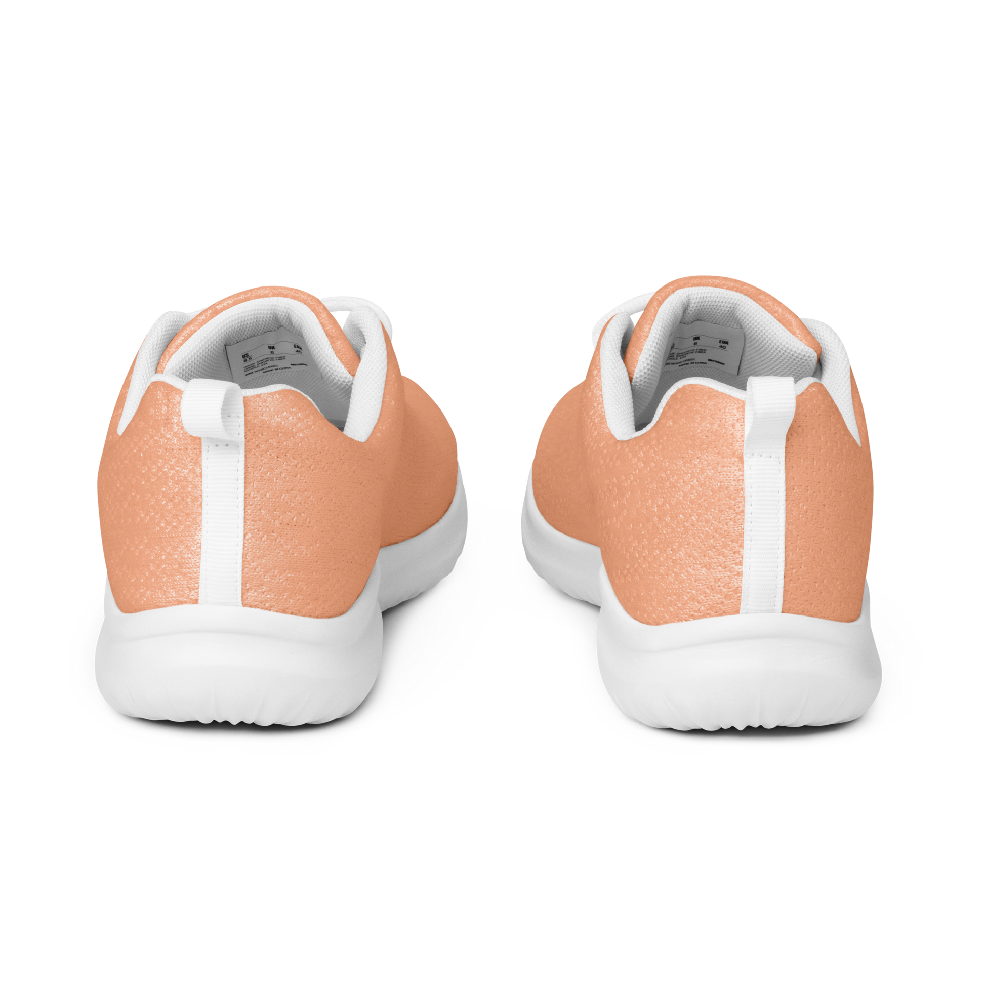 Coral running shoe with white laces on a reflective surface
