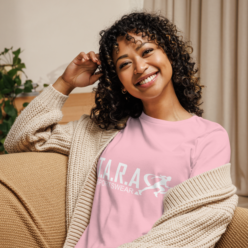 A Women is wearing a pink TARA sportswear T-Shirt sitting on a chair